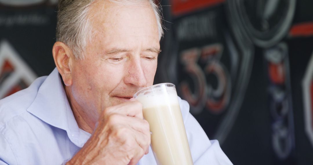 Elderly Man Drinking Latte in Coffee Shop - Free Images, Stock Photos and Pictures on Pikwizard.com