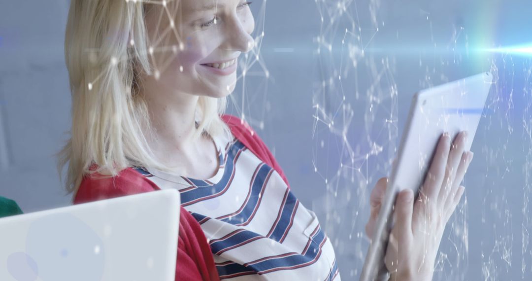 Smiling Woman Engages with Tablet and Digital Interface in Office