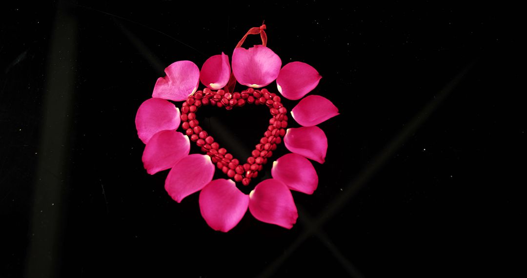A romantic arrangement of rose petals and red beads symbolizes love for special occasions. - Free Images, Stock Photos and Pictures on Pikwizard.com