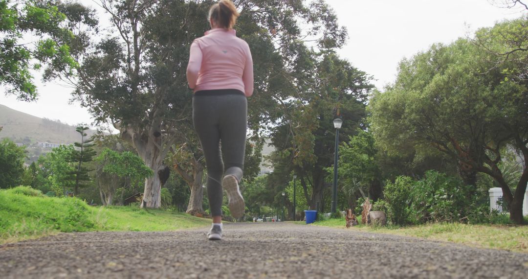 Woman Running on Park Trail in Activewear - Free Images, Stock Photos and Pictures on Pikwizard.com