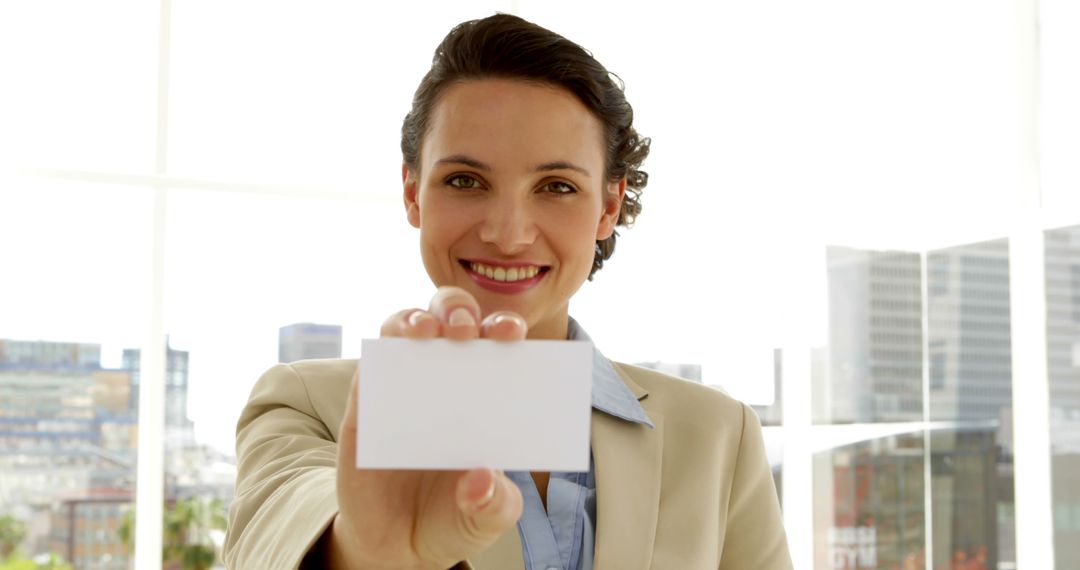 Professional Woman Holding Blank Business Card at Office - Free Images, Stock Photos and Pictures on Pikwizard.com