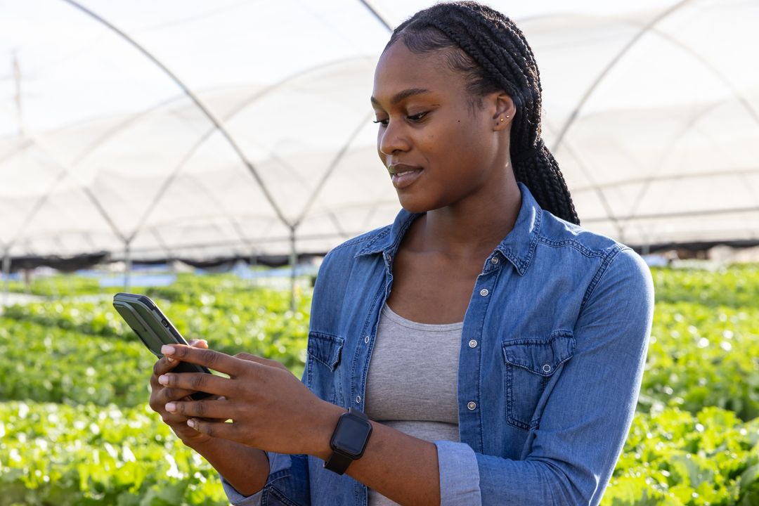 Modern Agriculture Specialist Monitors Crops with Smartphone Technology