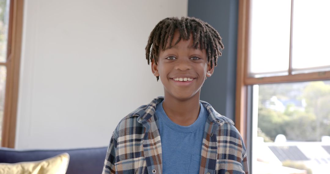 Smiling African American Boy with Dreadlocks Indoors - Free Images, Stock Photos and Pictures on Pikwizard.com