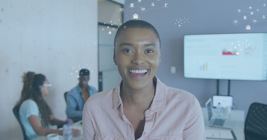 Smiling Professional with Digital Icons in Modern Office Workspace