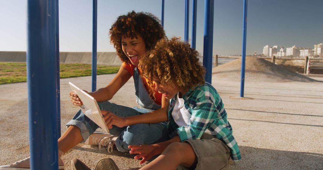 Mother and Son Enjoying Tablet at Sunny Playground - Free Images, Stock Photos and Pictures on Pikwizard.com