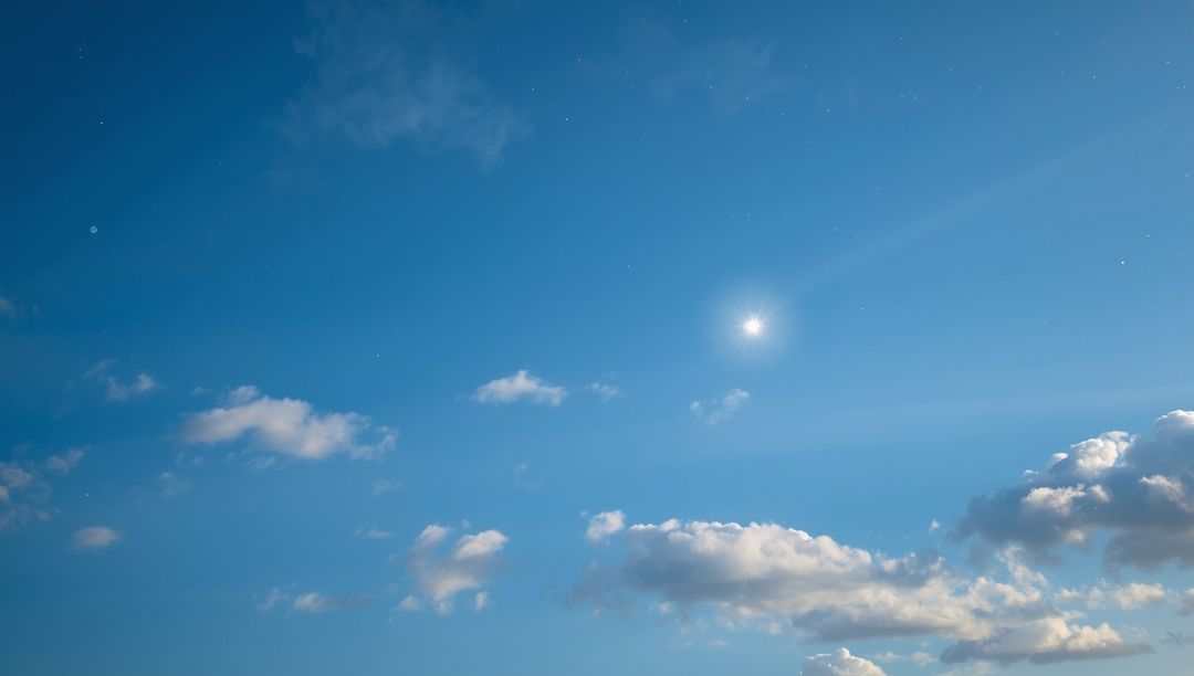 Sunny Blue Sky with Scattered Clouds Creating Serene Atmosphere