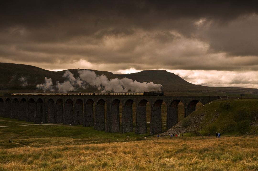 Historic Steam Train Crossing Majestic Stone Viaduct at Sunset - Free Images, Stock Photos and Pictures on Pikwizard.com