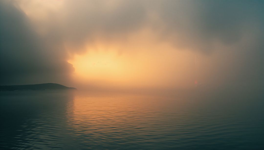 Golden Sunlight Breaks Through Clouds Over Serene Sea
