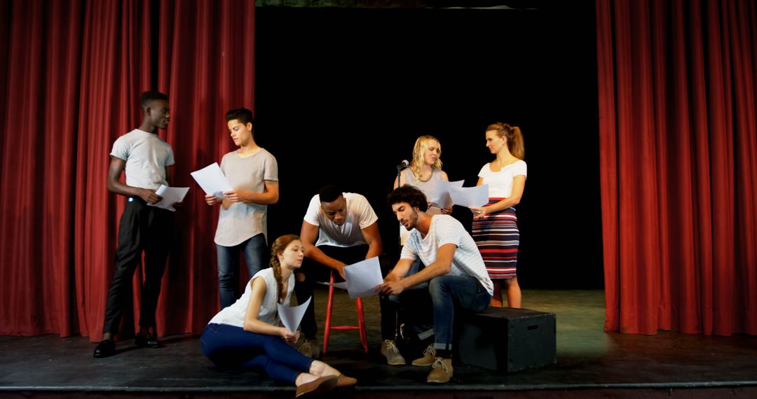 Group of Diverse Actors Rehearsing on Stage with Scripts - Free Images, Stock Photos and Pictures on Pikwizard.com