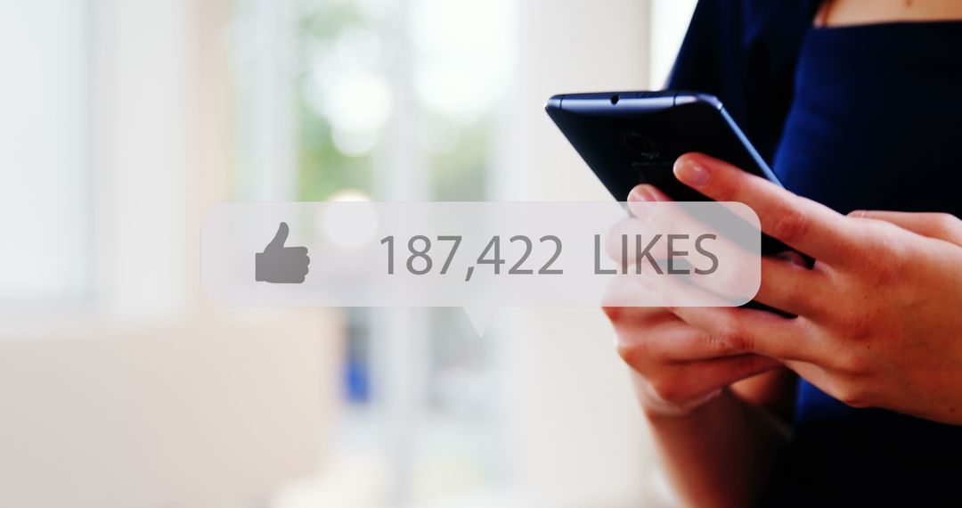 Hands Holding Smartphone with Social Media Notification