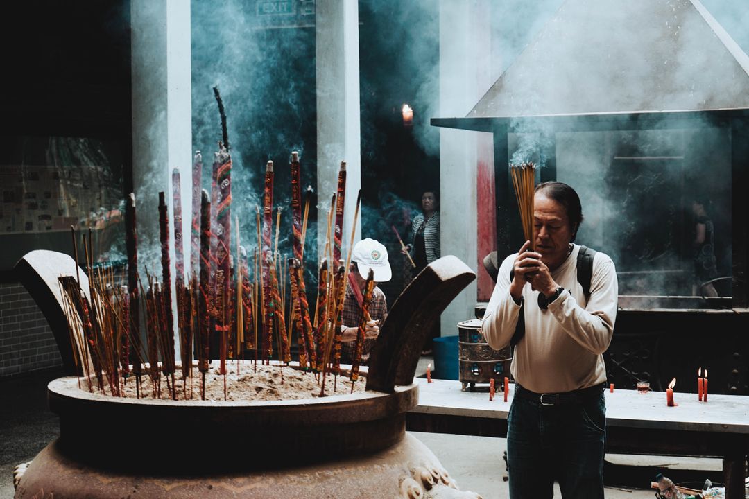 Man Praying with Incense Sticks in Traditional Asian Temple - Free Images, Stock Photos and Pictures on Pikwizard.com