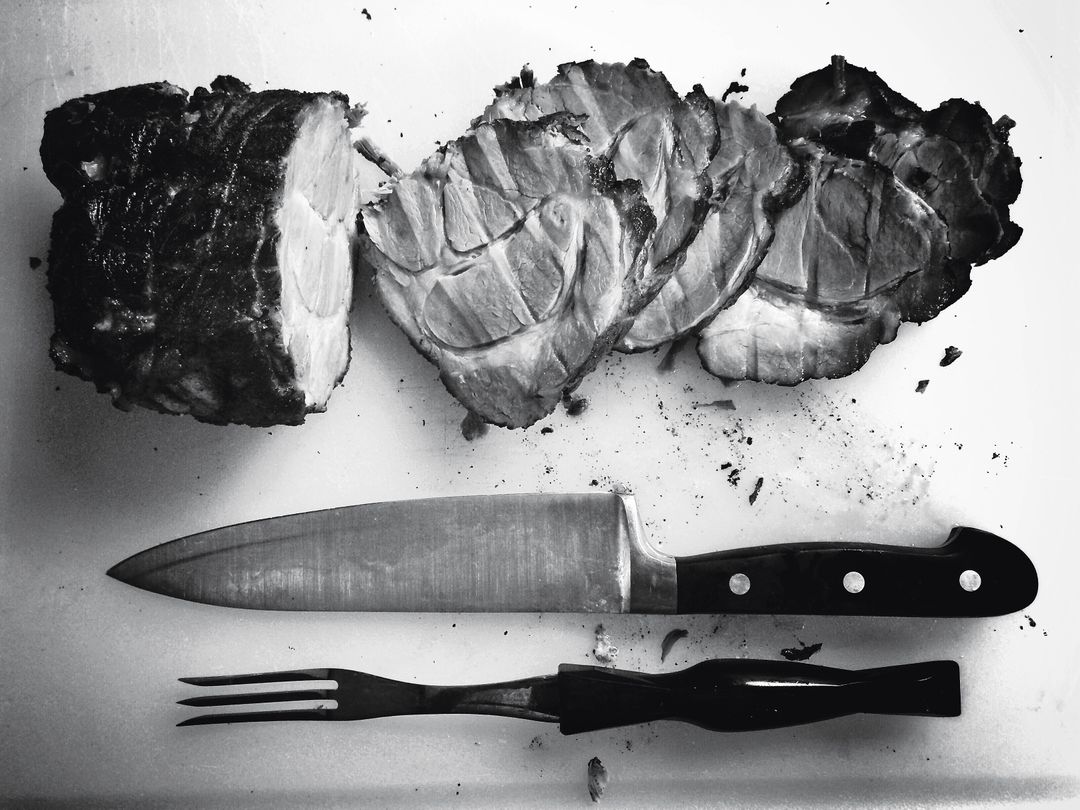 Black and White Sliced Meat with Knife and Fork on Cutting Board - Free Images, Stock Photos and Pictures on Pikwizard.com