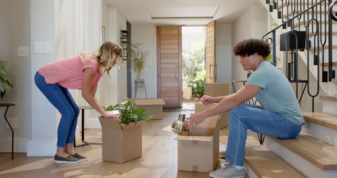 Couple Joyfully Unpacking in New Home