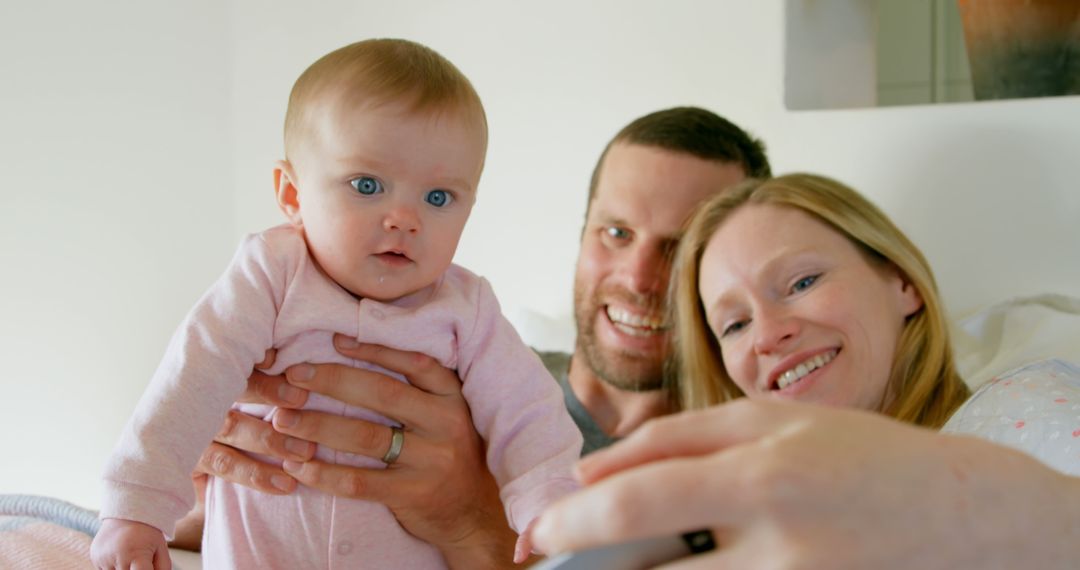 Young Family Taking Selfie with Infant at Home - Free Images, Stock Photos and Pictures on Pikwizard.com