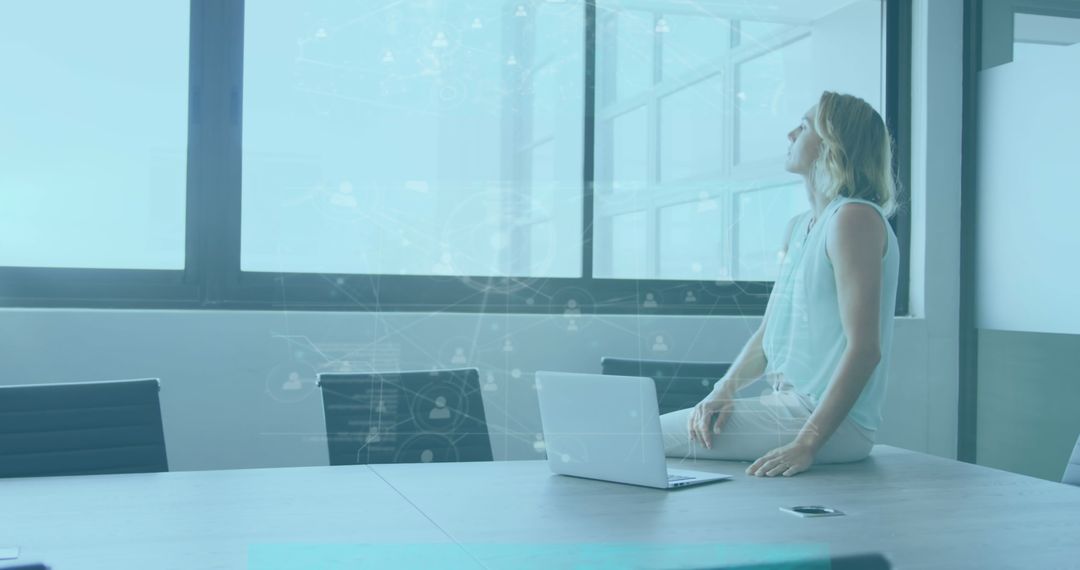 Businesswoman Analyzing Data on Her Laptop in Modern Office