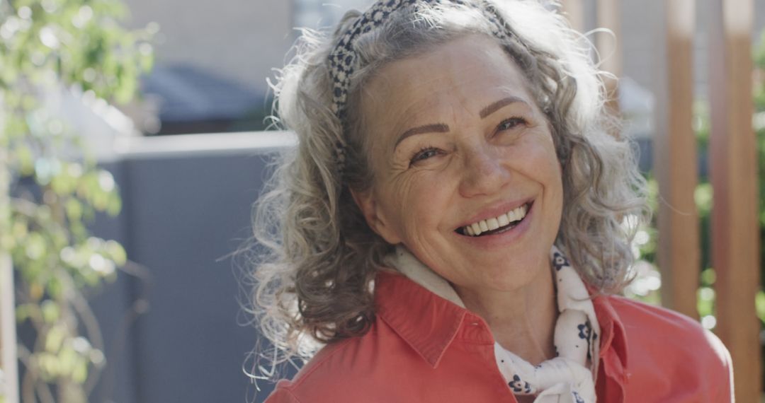 Smiling Senior Woman with Curly Gray Hair Enjoying Sunny Day Outdoors - Free Images, Stock Photos and Pictures on Pikwizard.com