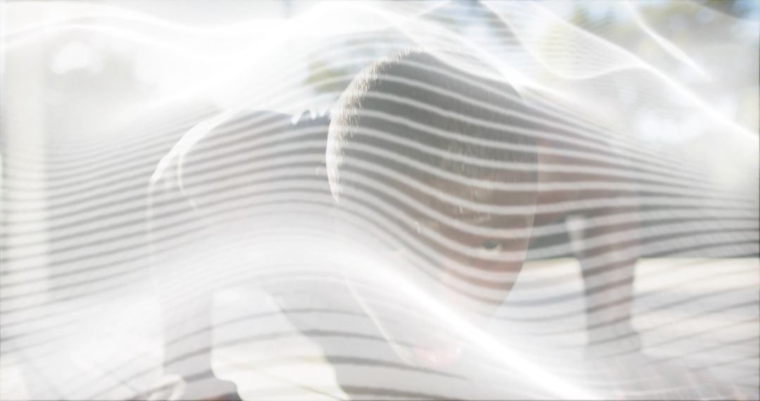 Backlit man bowing behind sheer wavy overlay, leaning in bright high-key interior