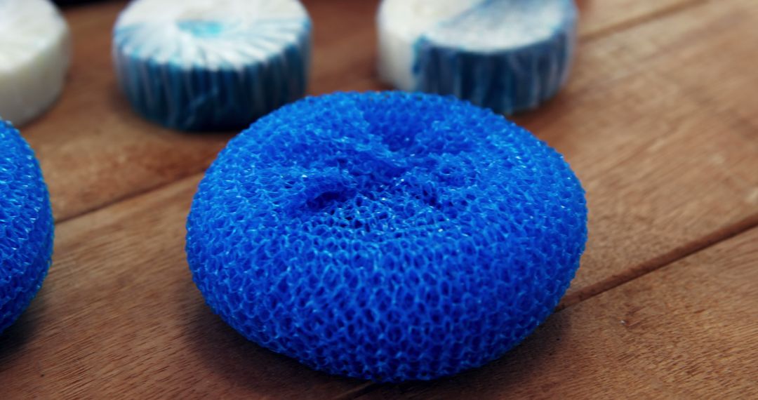 Close Up of Blue Mesh Scrubber on Wooden Surface - Free Images, Stock Photos and Pictures on Pikwizard.com