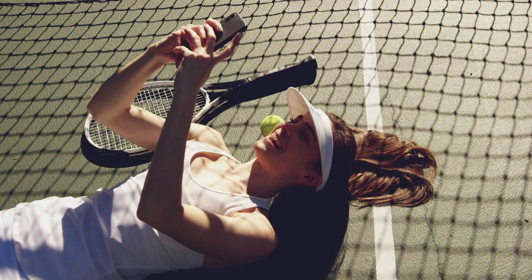 Female Tennis Player Lying on Court Checking Smartphone - Free Images, Stock Photos and Pictures on Pikwizard.com