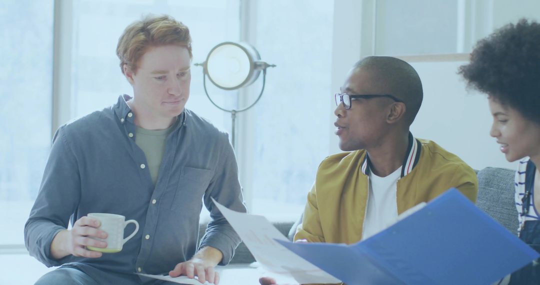 Diverse Team Collaborating in Office Lounge for Project Discussion