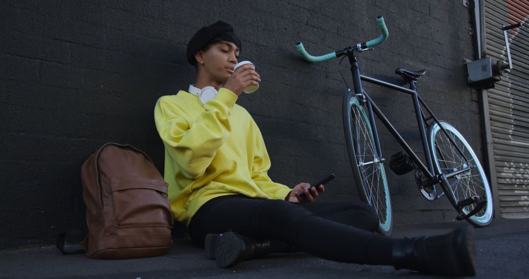 Man Relaxing by Bike with Coffee in Urban Setting