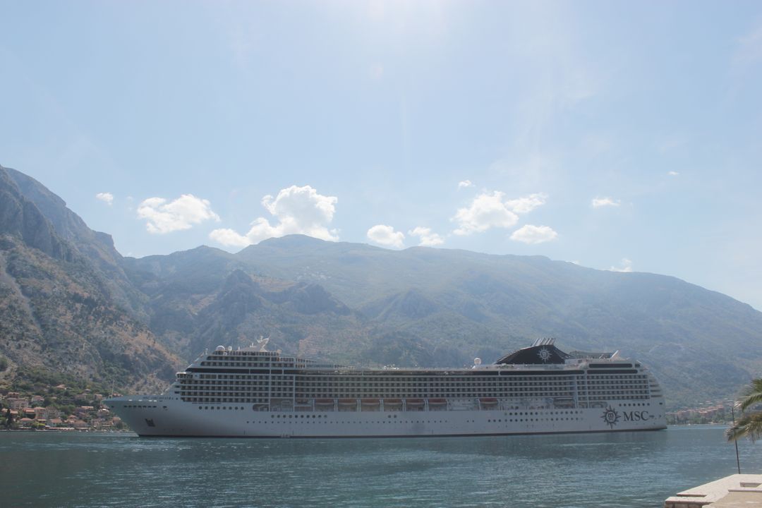 Luxury Cruise Ship on Scenic Mountainous Coastline - Free Images, Stock Photos and Pictures on Pikwizard.com