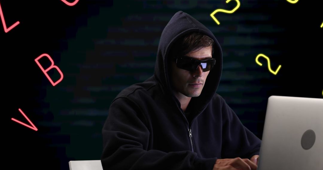 Hacker with Hoodie Using Laptop on Abstract Background