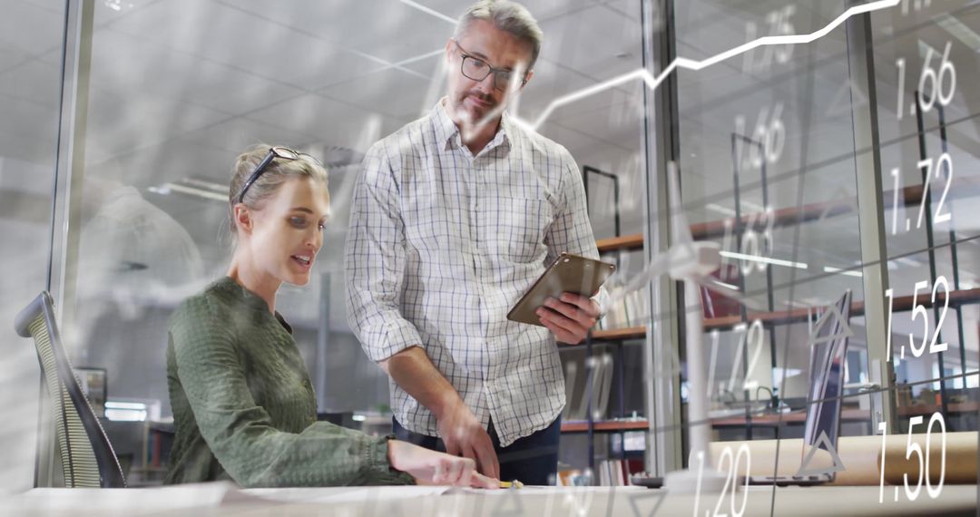 Colleagues Analyzing Financial Graphs with Digital Overlay in Office