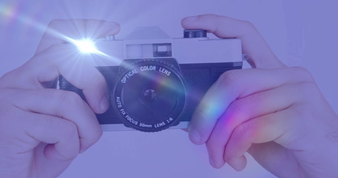 Retro Rangefinder Camera Capturing Photo with Flash and Lens Flares