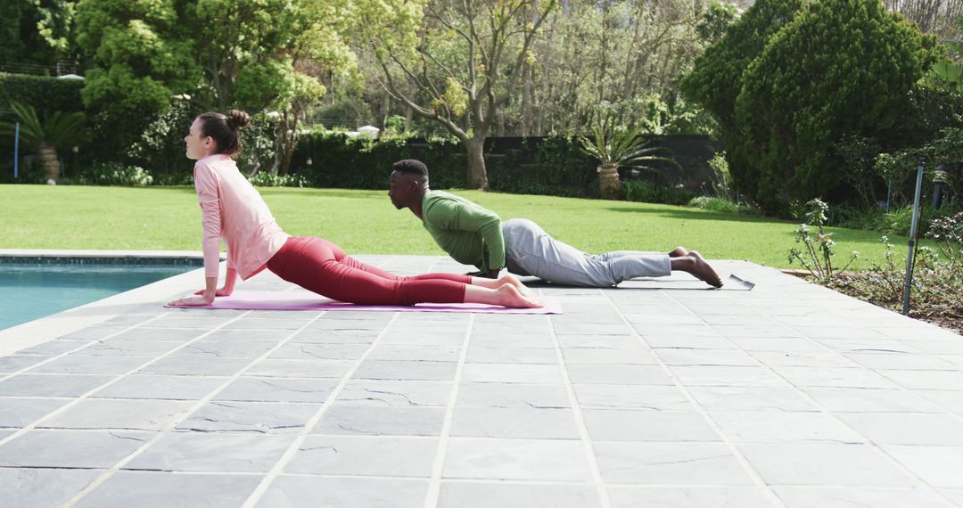 Couple Practicing Yoga in Tranquil Garden Setting