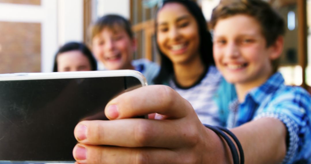 Smiling Group of Teenagers Taking a Selfie Outdoors - Free Images, Stock Photos and Pictures on Pikwizard.com