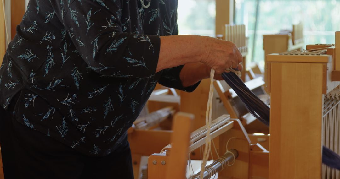 Senior Woman Operating Handloom Machine in Workshop