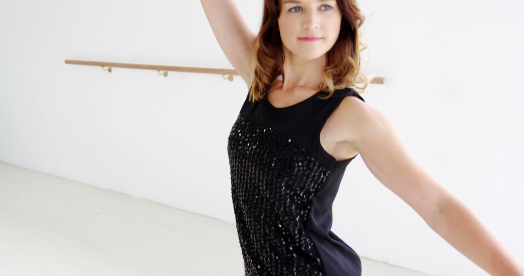Young Female Ballet Dancer in Studio Displaying Graceful Pose