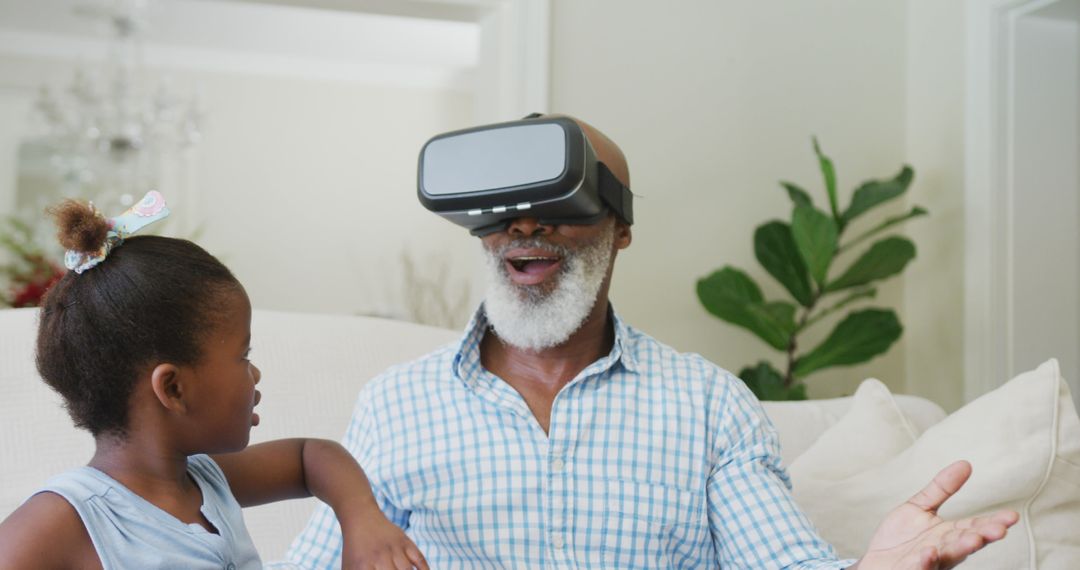 Grandfather Enjoying Virtual Reality with Granddaughter at Home