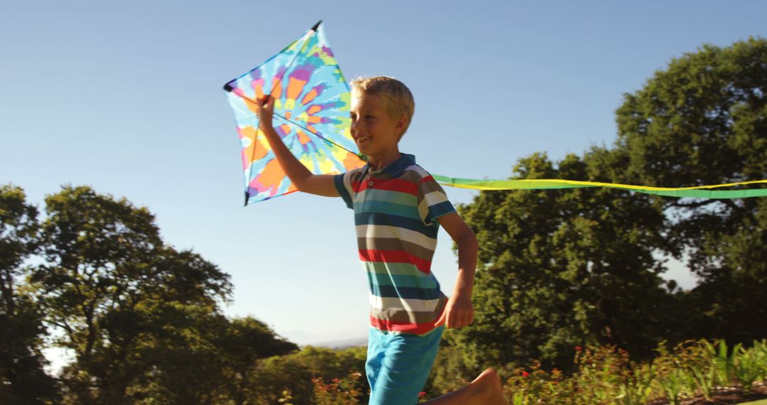 Joyful Boy Running with Colorful Kite in Park - Free Images, Stock Photos and Pictures on Pikwizard.com