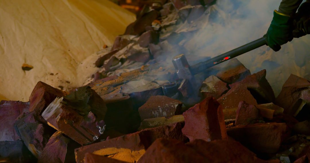 Worker Breaking Rocks with Sledgehammer in Dusty Environment - Free Images, Stock Photos and Pictures on Pikwizard.com