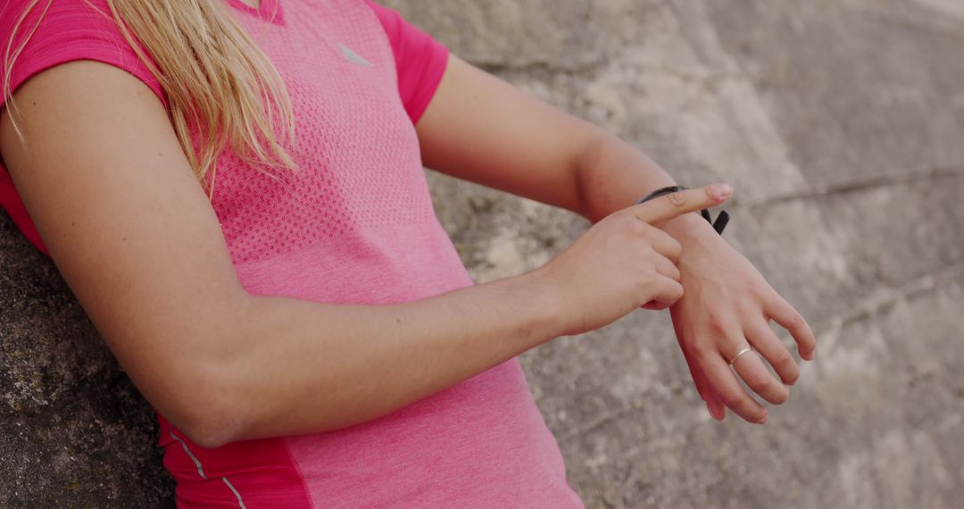 Female athlete using smartwatch for fitness tracking during outdoor workout - Free Images, Stock Photos and Pictures on Pikwizard.com