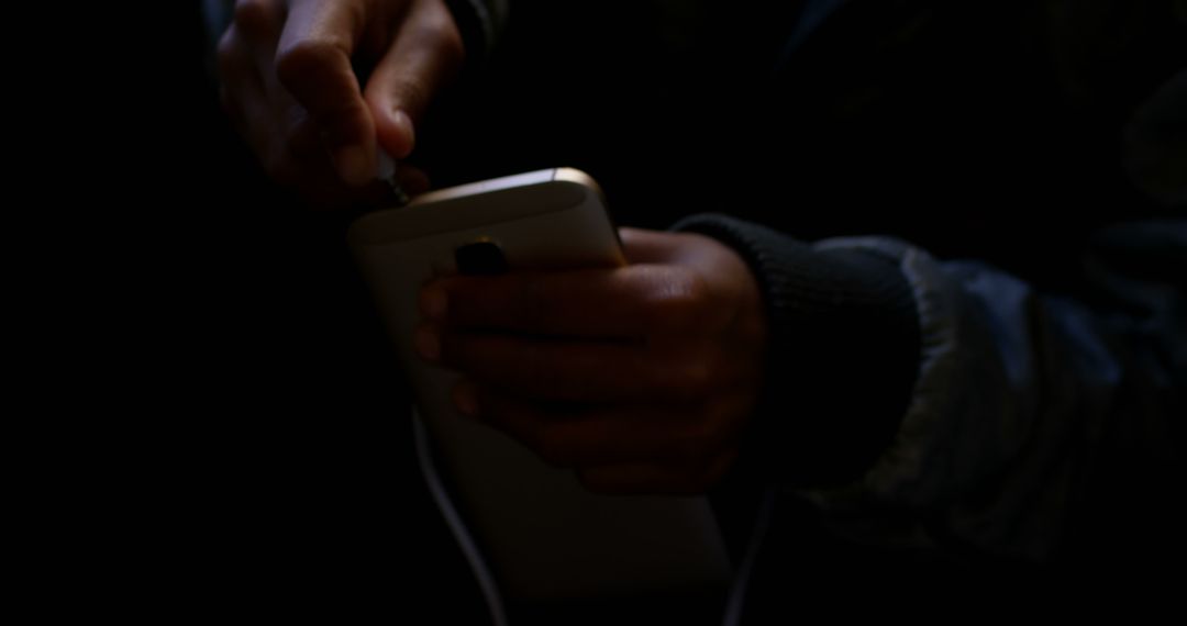 Hand Plugging Charger into Smartphone in Dark Room - Free Images, Stock Photos and Pictures on Pikwizard.com