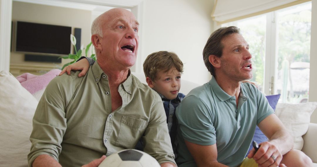 Three Generations Enjoying Soccer Match at Home