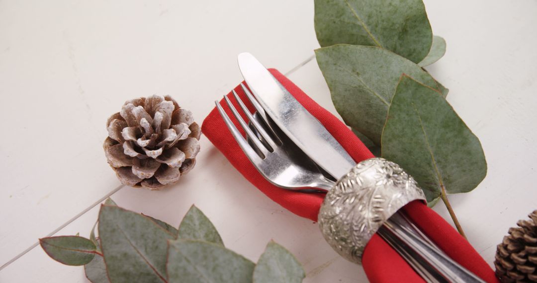 A holiday table setting with silverware and festive decor creates a cozy celebratory ambiance. - Free Images, Stock Photos and Pictures on Pikwizard.com