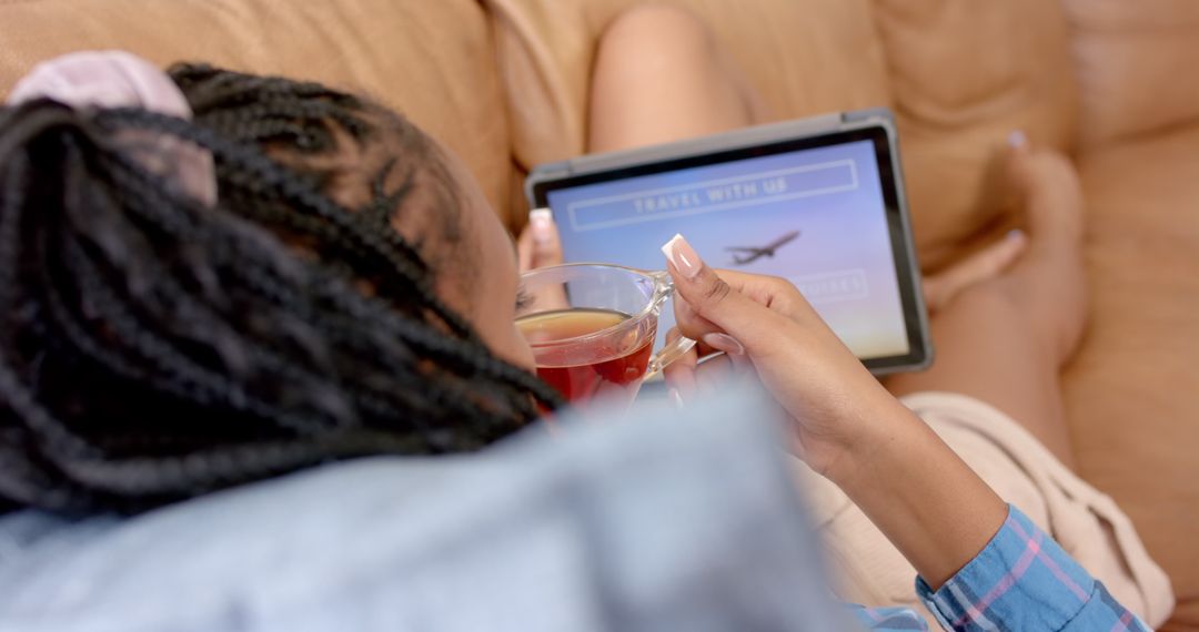 Young Woman Relaxing While Booking Travel Online with Tablet