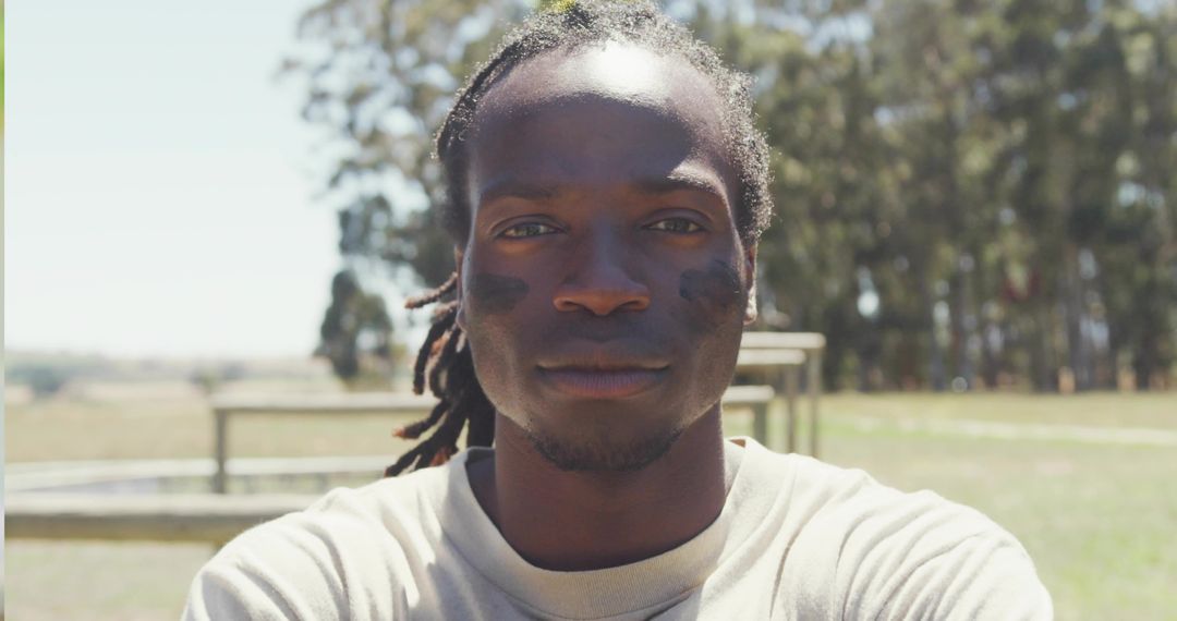 Athlete Showing Determination on Field with Eye Black