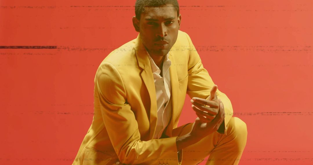 Confident Male Model in Vibrant Yellow Suit With Glitch Effect