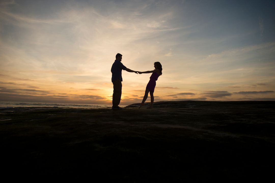Silhouette of a Couple Holding Hands at Sunset - Free Images, Stock Photos and Pictures on Pikwizard.com