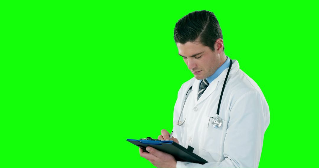 Caucasian Male Doctor Writing Notes on Clipboard with Green Background and Copy Space - Free Images, Stock Photos and Pictures on Pikwizard.com