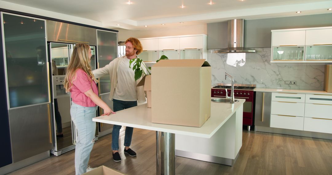 Joyful Couple Unpacking in Modern Kitchen During Move
