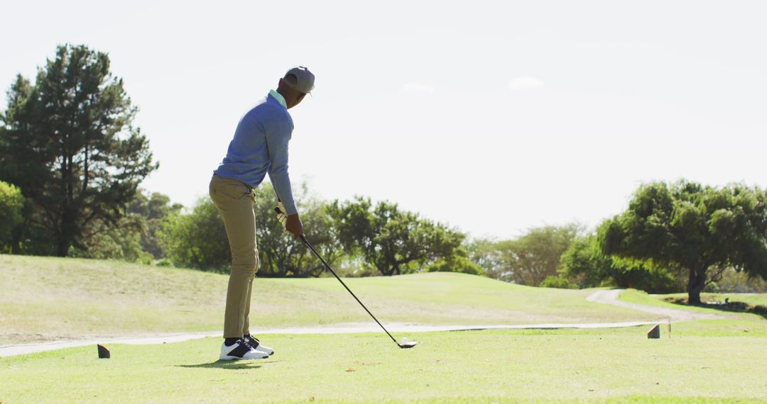 Image of african american man playing golf on golf filed - Free Images, Stock Photos and Pictures on Pikwizard.com