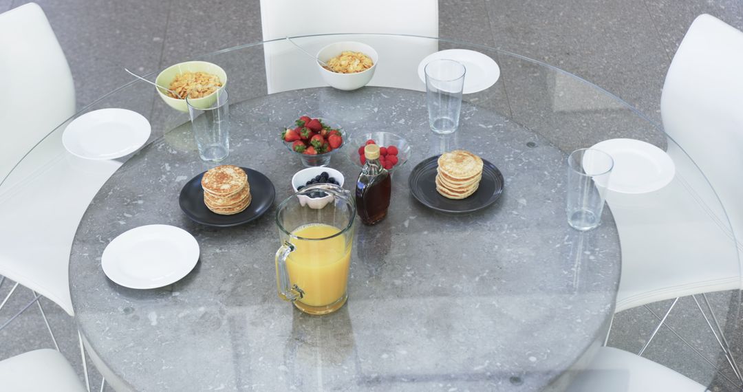 Modern Breakfast Table with Pancakes, Fruit, and Juice