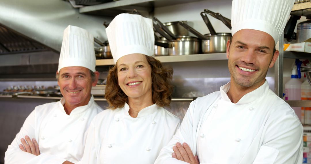 Happy Chefs in Kitchen Wearing White Uniforms and Hats - Free Images, Stock Photos and Pictures on Pikwizard.com