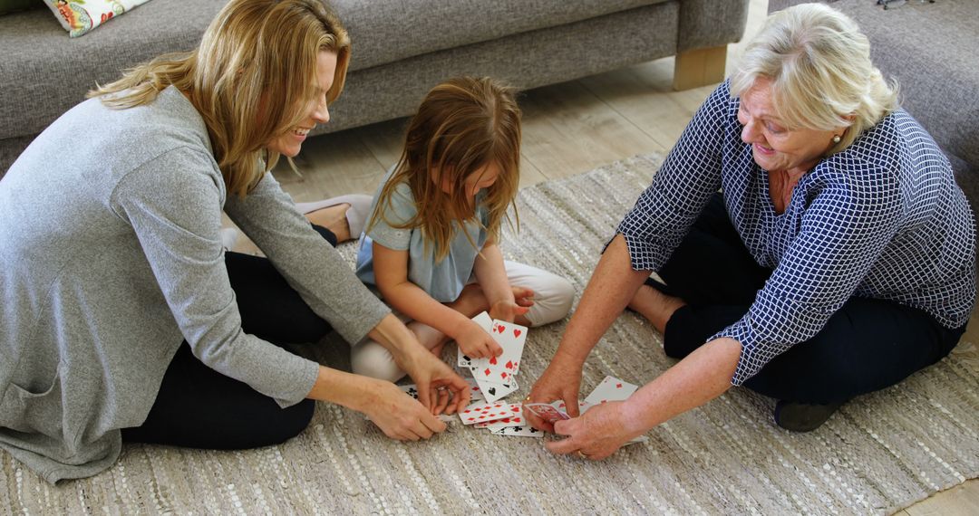 Three Generations of Women Playing Cards on Living Room Floor - Free Images, Stock Photos and Pictures on Pikwizard.com